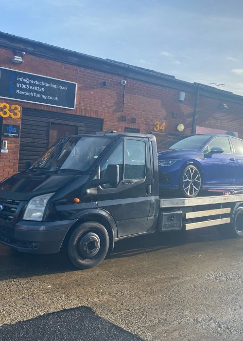 Tow truck safely transporting a customer’s vehicle during breakdown.”